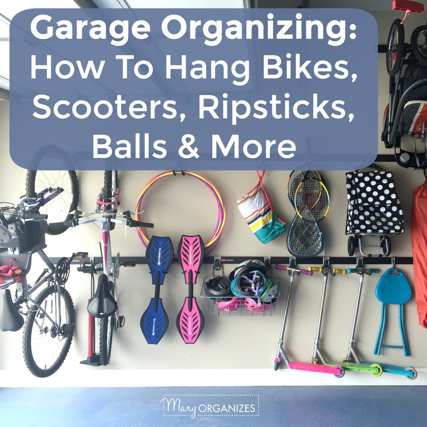 Wall-mounted stroller hook in garage holding a folded blue jogging stroller above floor with broom nearby