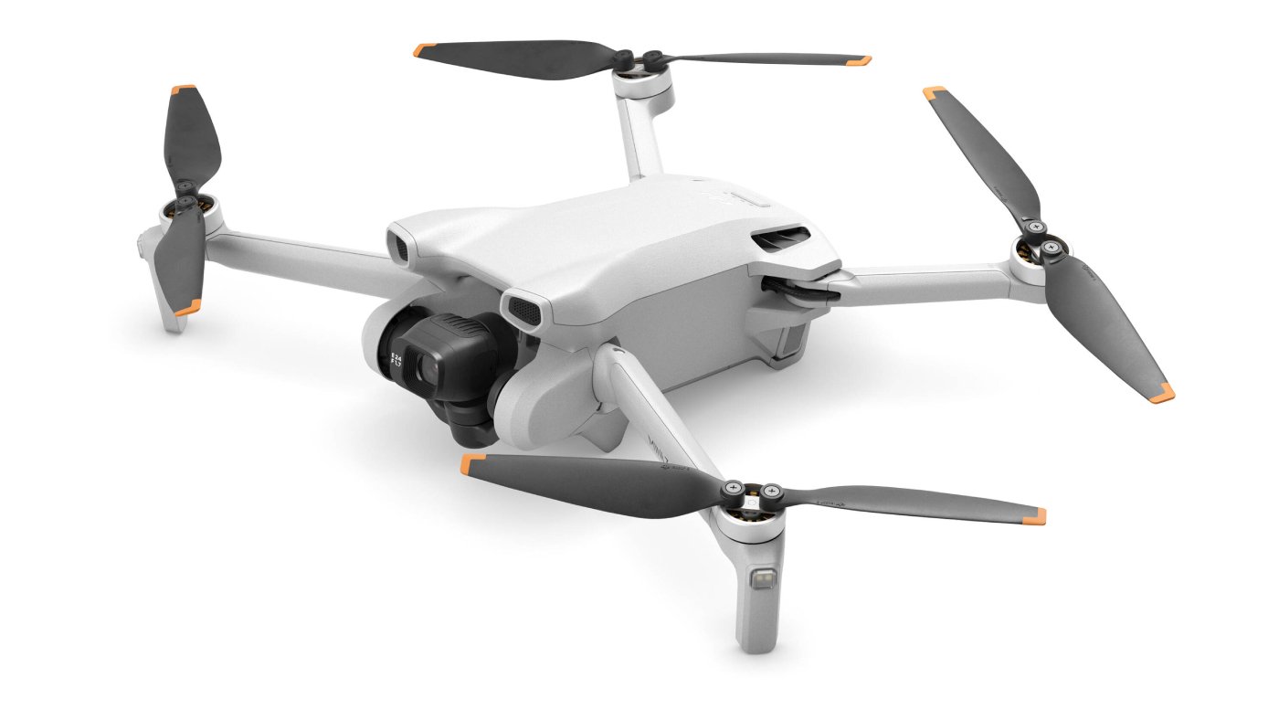 DJI consumer drone hovering near a residential backyard at dusk with sound wave visualization overlay emphasizing noise measurement